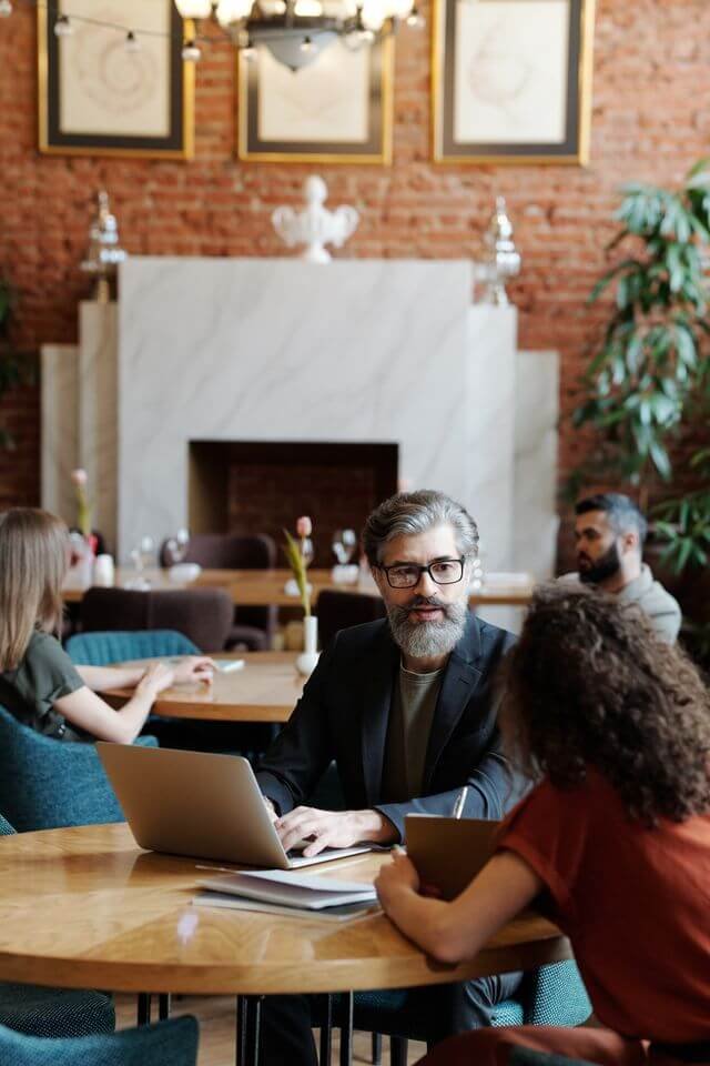 Professional working on a laptop during a financial consulting session